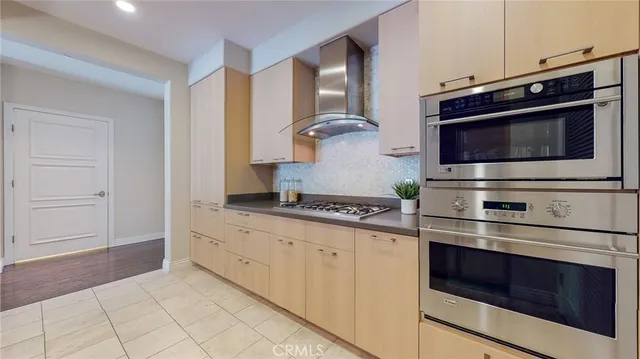 a kitchen with stainless steel appliances a stove and a microwave