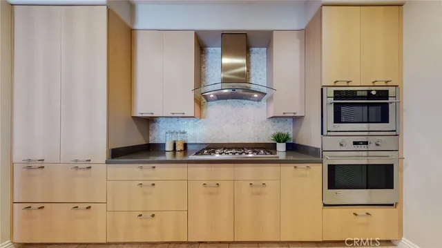 a kitchen with stainless steel appliances granite countertop a stove a sink and white cabinets