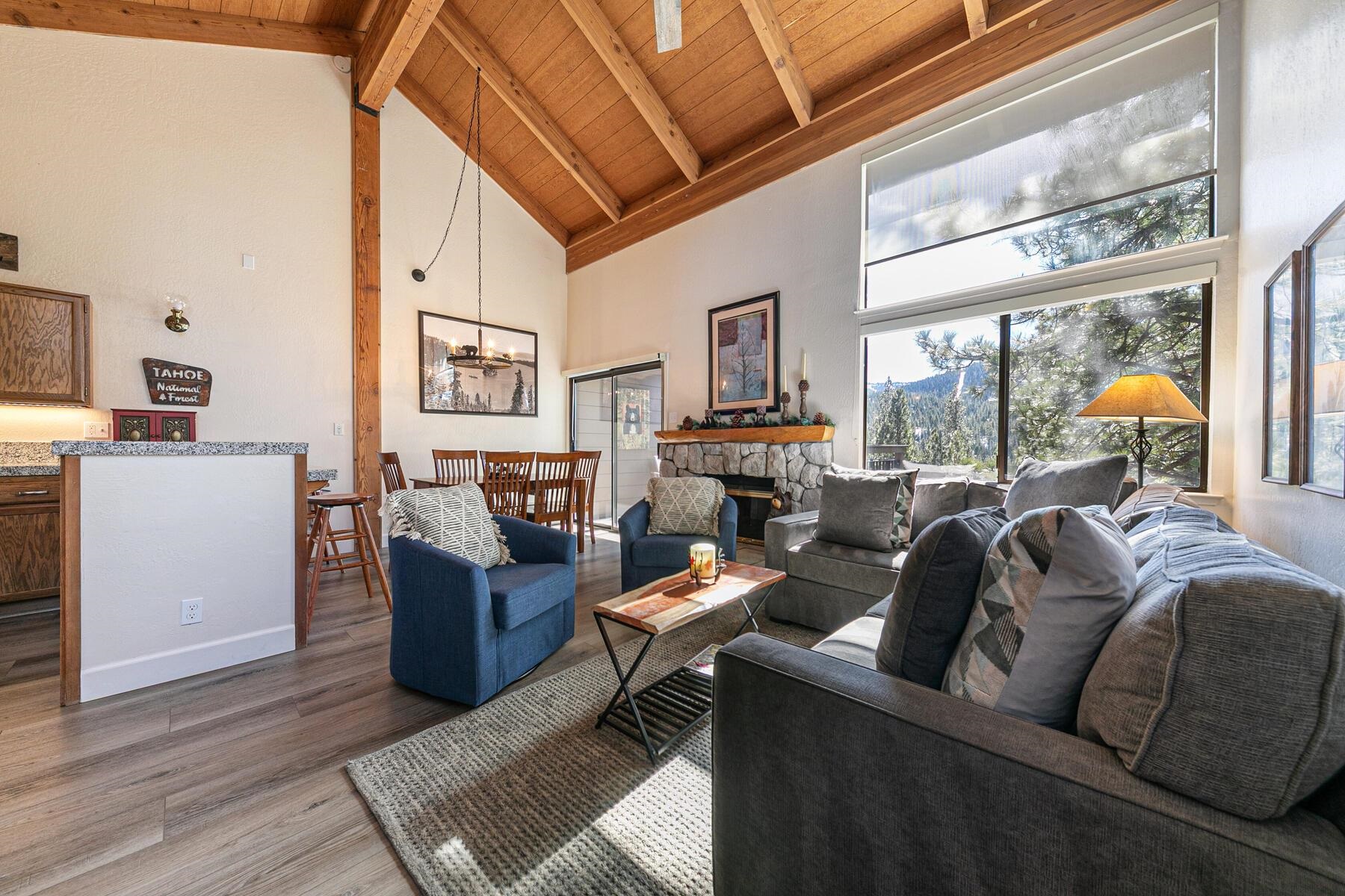 a living room with furniture a fireplace and a large window