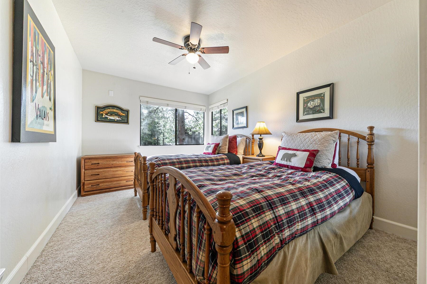 6092 Rocky Point Truckee, CA 96161 - Photo 22 of 27 a bedroom with a bed a chandelier and a dresser