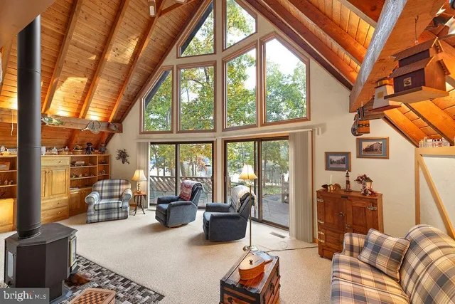 a living room with furniture and a floor to ceiling window