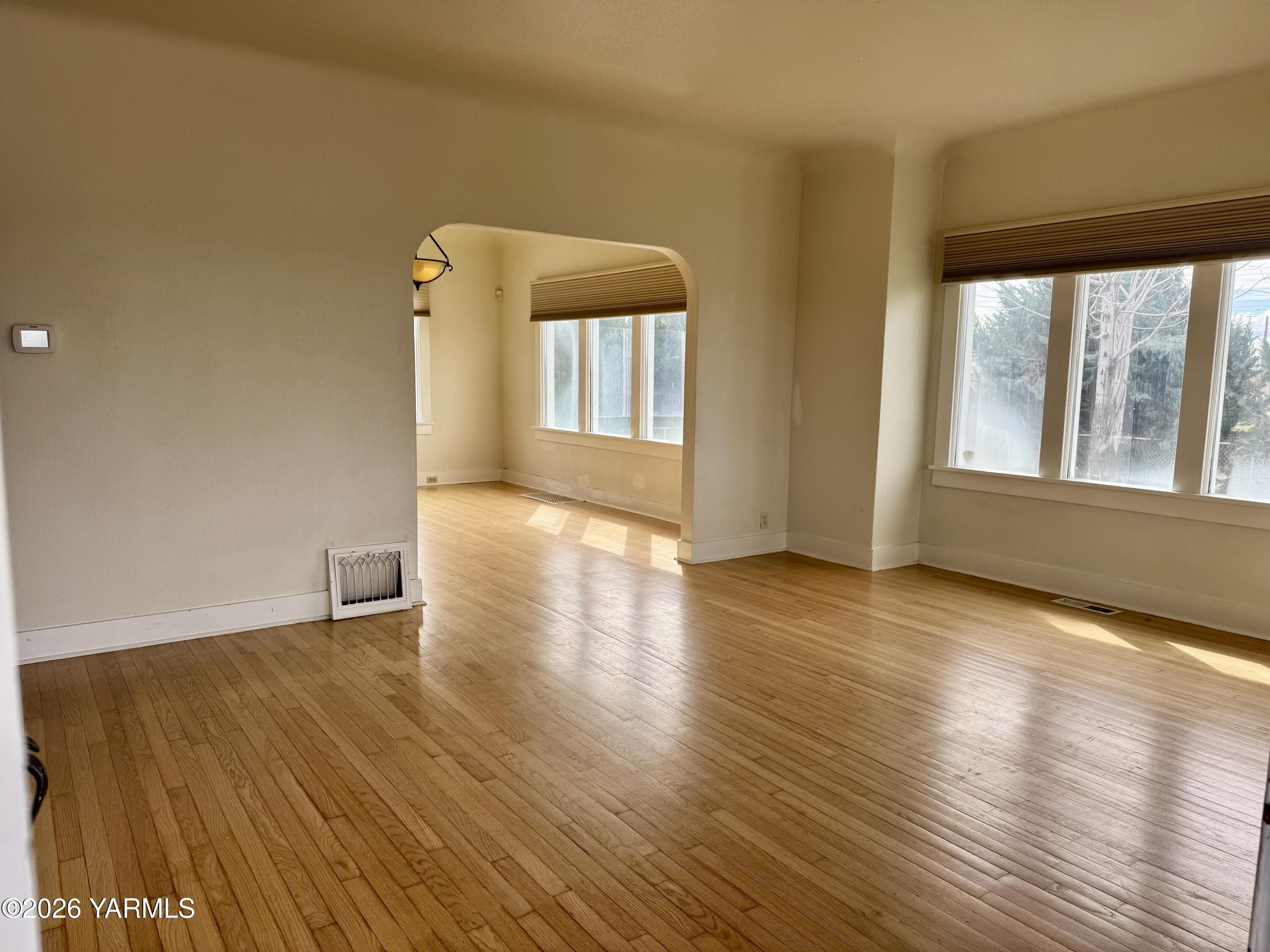 7801 Campbell Road, Unit 1 Toppenish, WA 98948 - Photo 9 of 46 a view of an empty room with wooden floor and a window