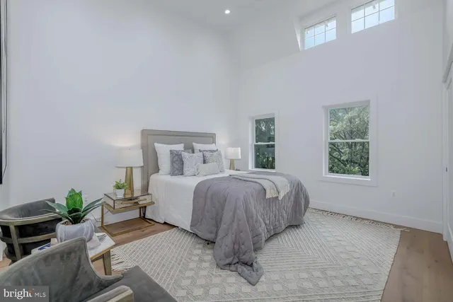 a living room with white cabinets and potted plant