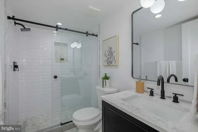 a bedroom with a bed and a lamp with wooden floor