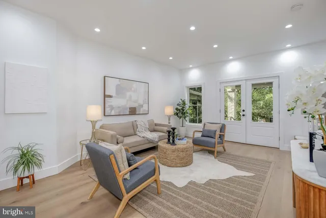 a living room with furniture and a dining table with wooden floor