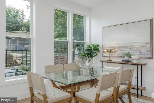 a kitchen with stove a sink and chairs