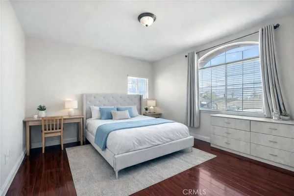 a bedroom with a bed and a large window