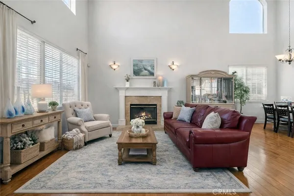 a living room with furniture wooden floor and a fireplace