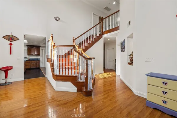 a view of entryway and hall with wooden floor