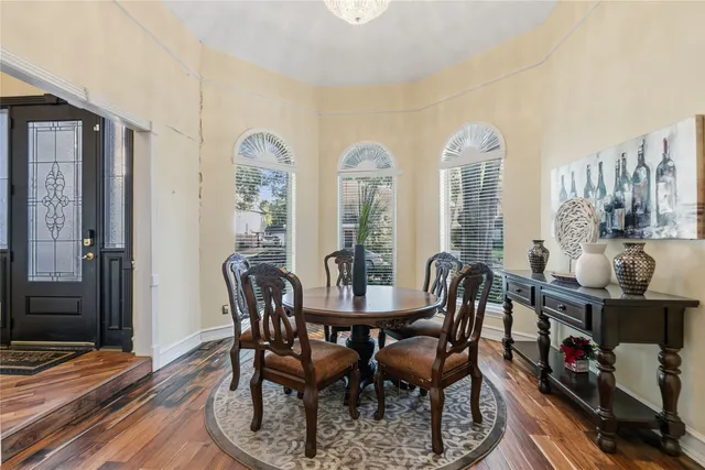 a view of a dining room with furniture and chandelier
