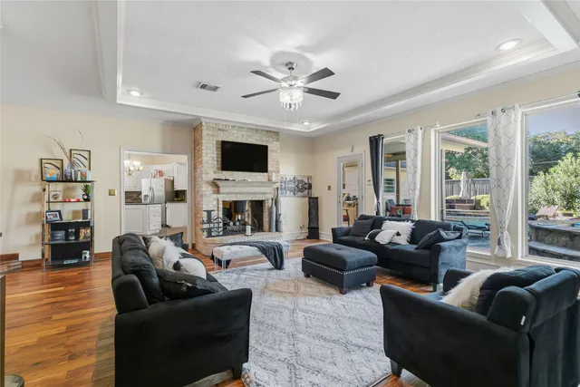 a living room with furniture fireplace and a large window