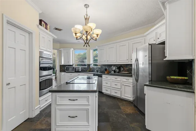 a kitchen with stainless steel appliances granite countertop cabinets and a counter top space