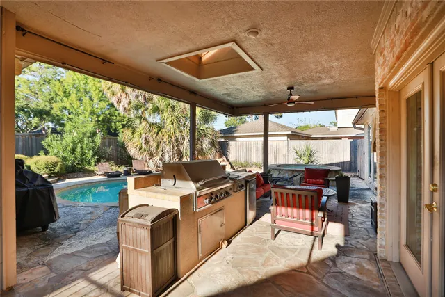 a outdoor space with chairs a stove and white kitchen view