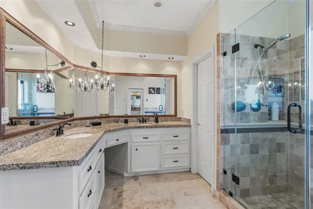 a bathroom with a granite countertop sink mirror and shower