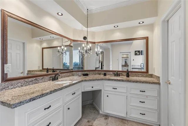 a bathroom with a granite countertop sink double and mirror
