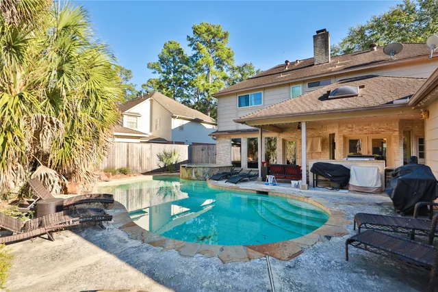 a view of a house with backyard porch and sitting area