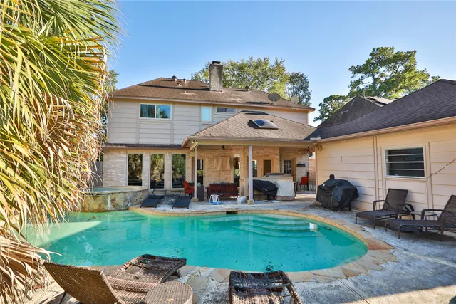 a view of a patio with table and chairs potted plants and a large tree