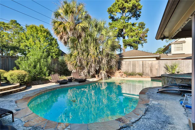 a view of a swimming pool with a patio