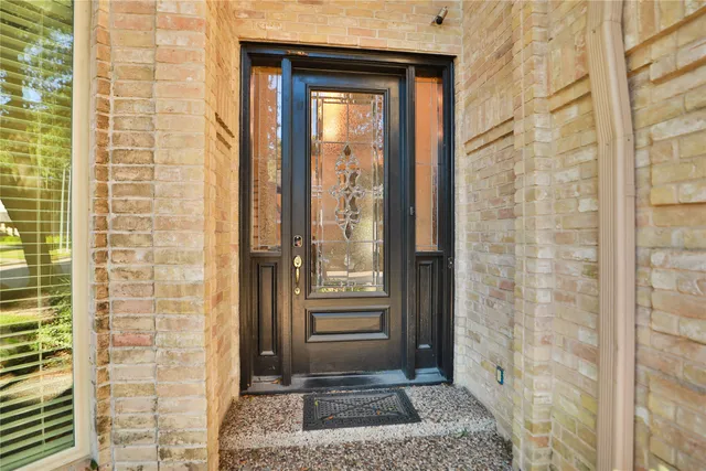 a view of a door and brick walls