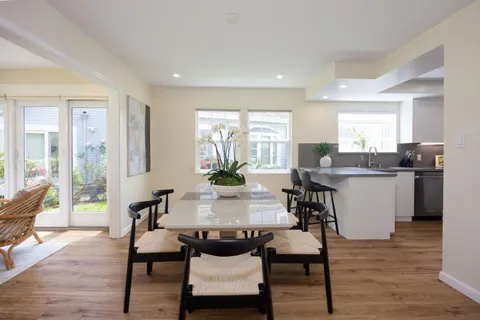 a view of a dining room with furniture and wooden floor