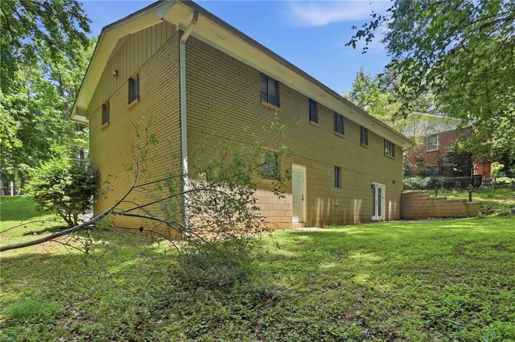 4505 Wonder Valley Trail Decatur, GA 30034 - Photo 31 of 34 a yellow house with garden in front of it