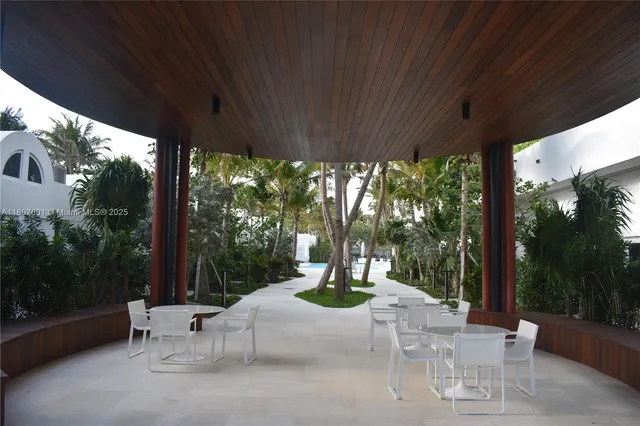 a palm tree sitting in front of a house with a yard