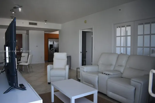 a kitchen with stainless steel appliances a stove microwave and sink