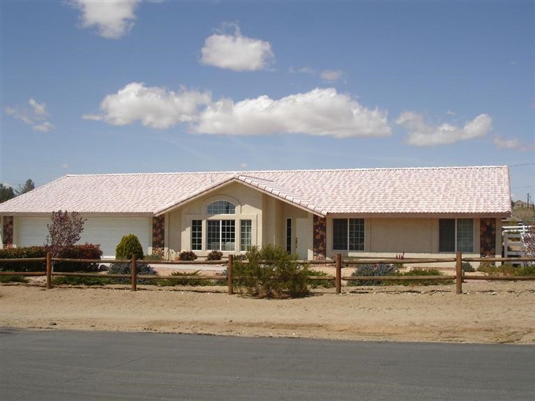 16238 St Timothy Road Apple Valley, CA 92307 - Photo 1 of 1 a front view of a house with a yard