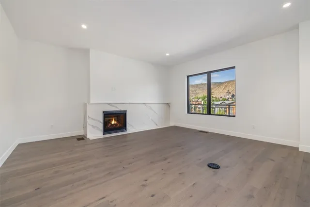 a large kitchen with stainless steel appliances a large counter top a sink a stove and a refrigerator