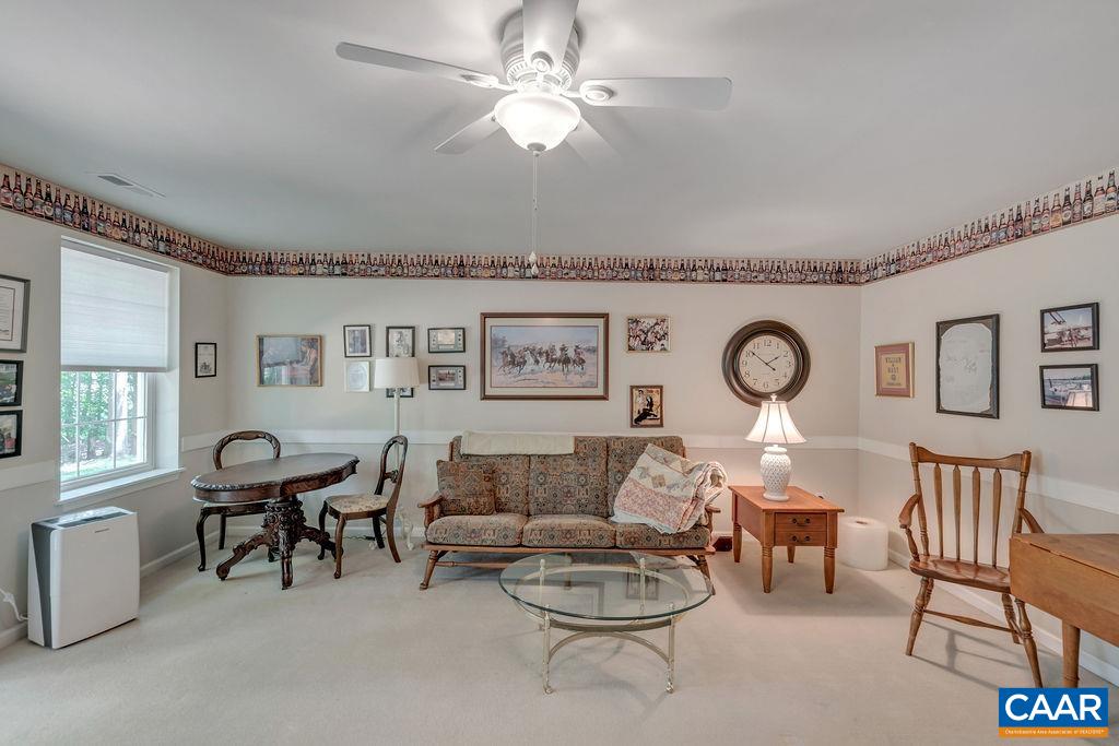31 Out Of Bounds Road Palmyra, VA 22963 - Photo 24 of 41 a living room with furniture a chandelier fan and a window