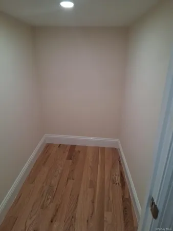a view of a room with wooden floor and white walls