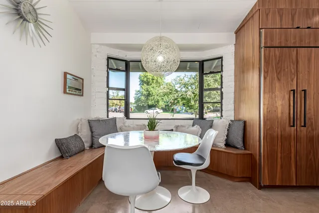 a living room with furniture a fireplace and a large window