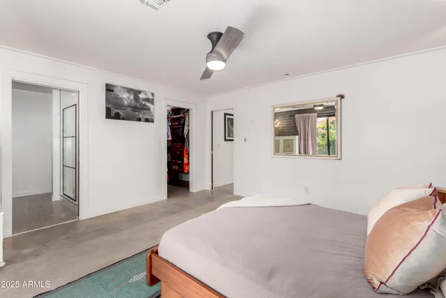 a bedroom with a large bed and a window