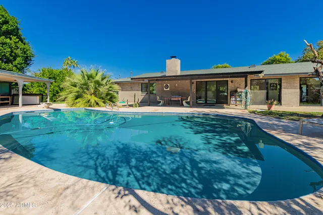 a bedroom with furniture and a large window