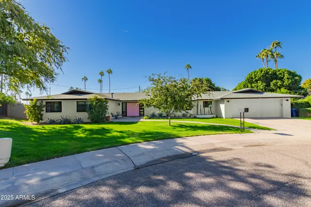 a front view of a house with a yard and a garage