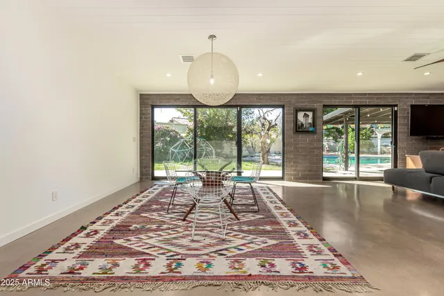 a view of an empty room with a window and a mirror