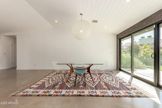 a very nice looking living room with a rug table and a large window