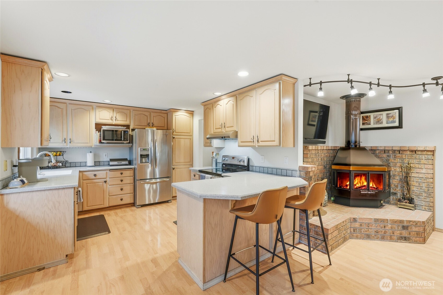 15003 104th Avenue Northeast Bothell, WA 98011 - Photo 15 of 40 a kitchen with stainless steel appliances granite countertop a stove top oven a sink dishwasher and a refrigerator with the cabinets