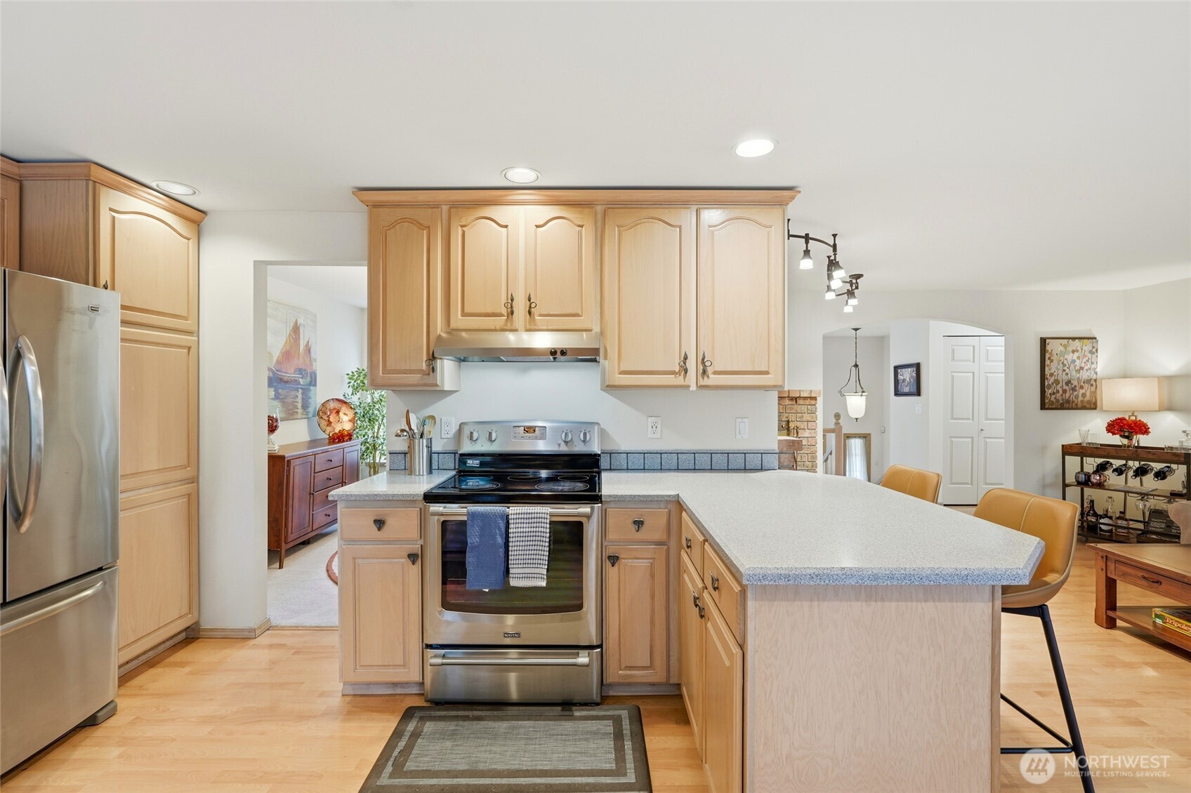 15003 104th Avenue Northeast Bothell, WA 98011 - Photo 16 of 40 a kitchen with a stove a refrigerator and a stove top oven
