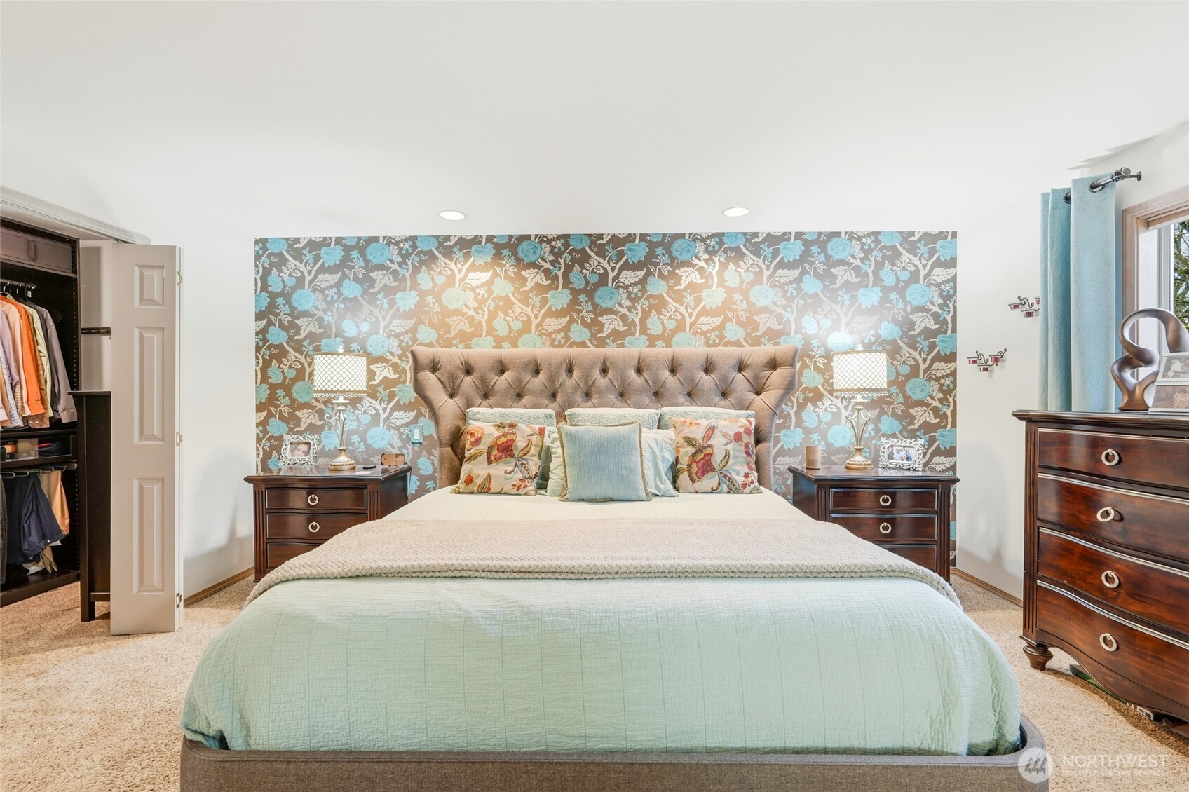 15003 104th Avenue Northeast Bothell, WA 98011 - Photo 21 of 40 a bedroom with a large bed and a flat tv screen on dresser