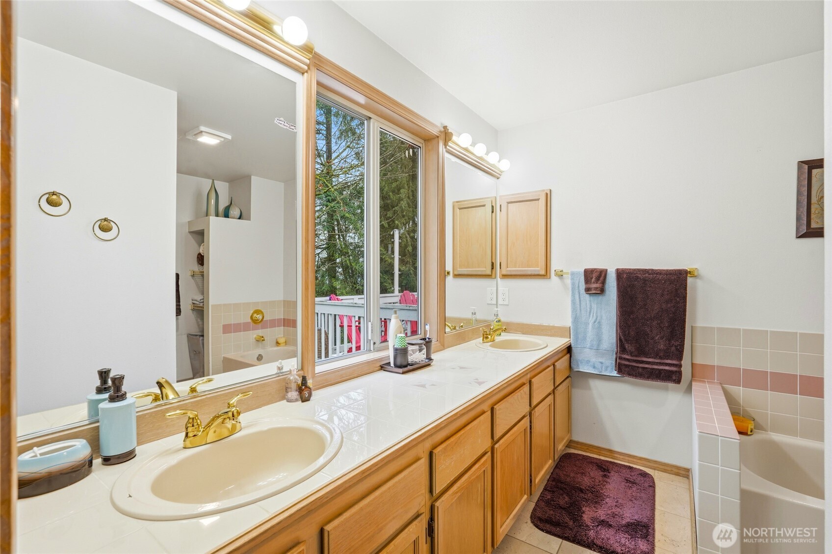 15003 104th Avenue Northeast Bothell, WA 98011 - Photo 23 of 40 a bathroom with a double vanity sink a mirror and a shower