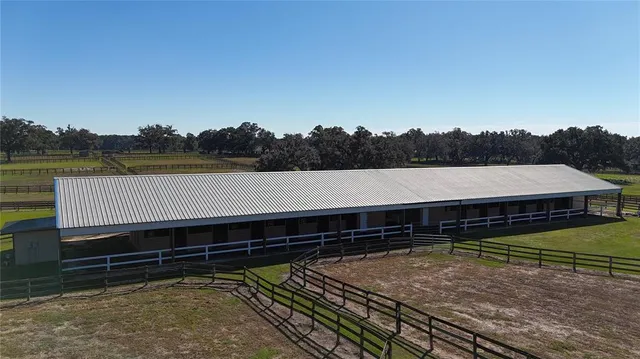 a view of a backyard with a deck and a garden