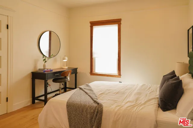 a bedroom with a bed and a table