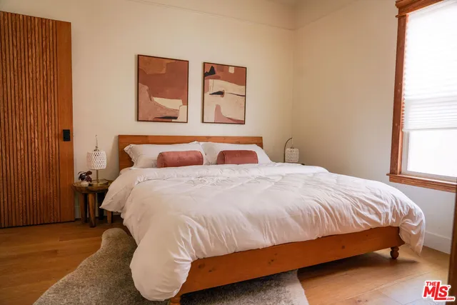 a bedroom with a bed and window