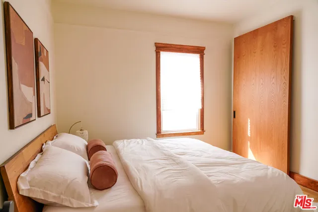 a bed room with a bed and a painting