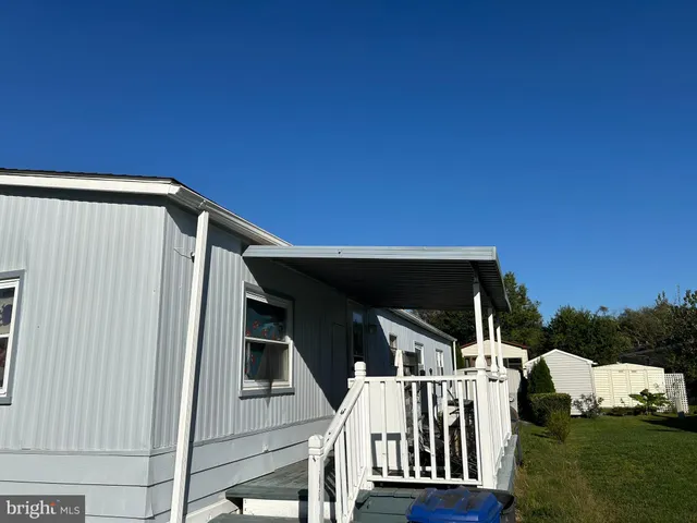 a view of house with backyard and deck
