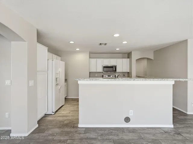 a view of kitchen with appliances and cabinets
