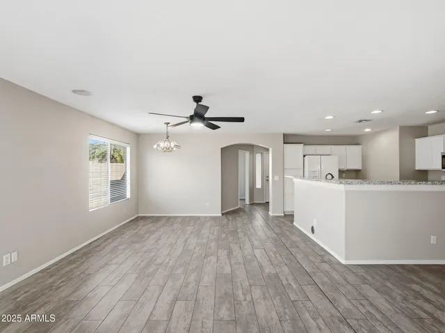 a kitchen with stainless steel appliances granite countertop a sink a stove and a refrigerator