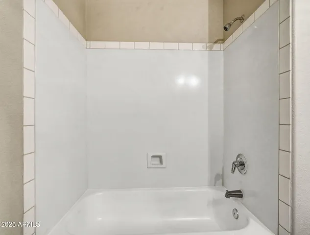 a bathroom with a granite countertop sink a toilet and a mirror