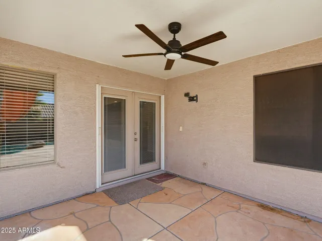 a view of a livingroom with a ceiling fan and window
